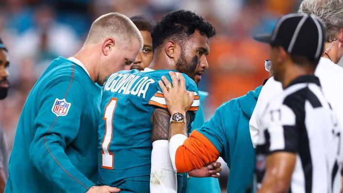 Tua Tagovailoa leaves the field in Miami's game against the Buffalo Bills on September 12