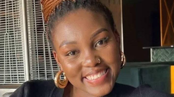 A close-up of Olorato Mongale smiling and wearing earrings