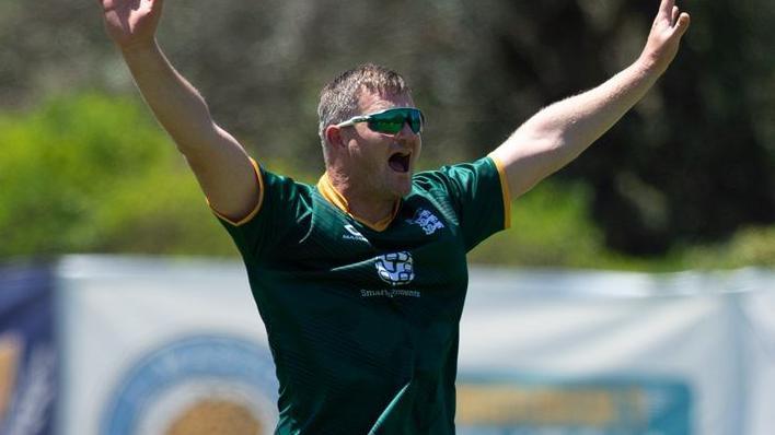 Guernsey bowler celebrates a wicket