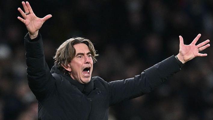 Thomas Frank puts his arms out and shouts in frustration