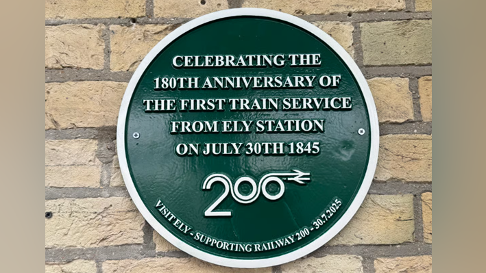 Circular wall plaque with the words: "Celebrating the 180th anniversary of the first train service from Ely station on July 30th 1945" with the logo for the event Railway 200
