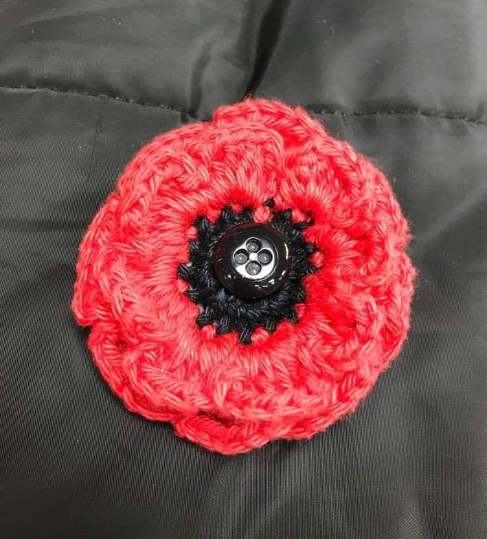 Knitted poppy badge