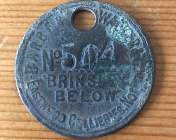 The well-worn miners tag on a wooden surface