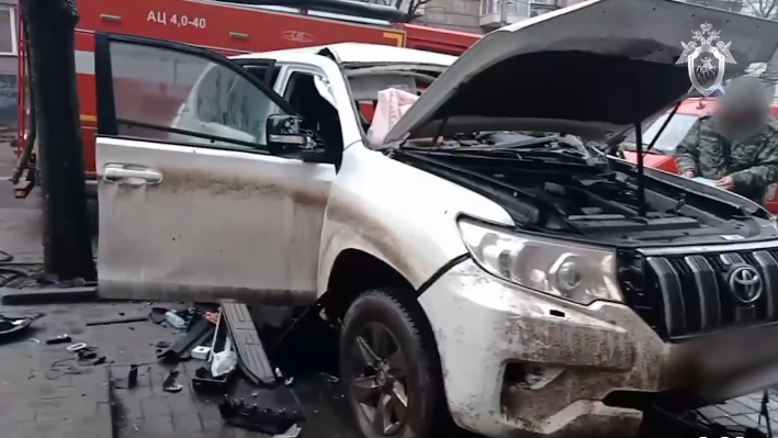 The burnt-out remains of a white SUV where the attack happened