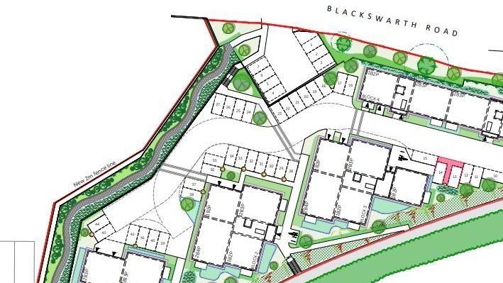 An architect's drawing of a proposed new housing development. All of the car parking spaces are plotted out and a red line marks the boundary. The flats are marked in rectangular black boxes.