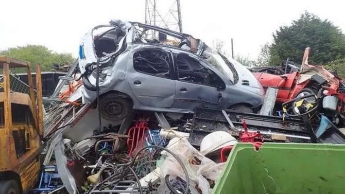 An old car on a heap of scrap metal