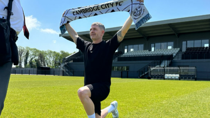 Jamie Cureton holds up a Cambridge City scarf