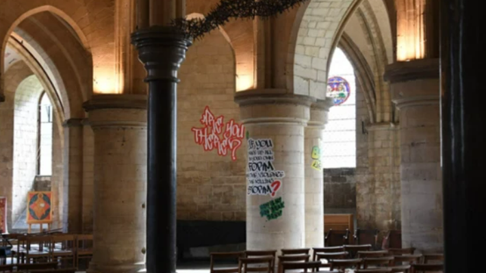 Graffiti written on walls and posts within Canterbury cathedral