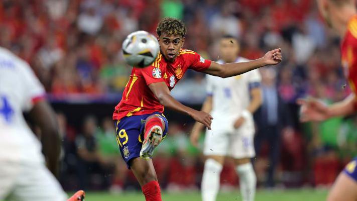 Spain's 16 year old sensation Lamine Yamal kicking the ball against France