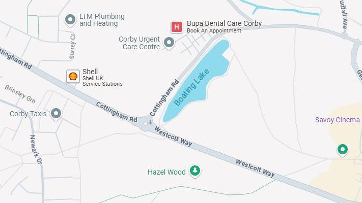 Map showing a road (Cottingham Road / Westcott Way). There is a large blue shape representing the boating lake at the junction between the two roads. Hazel Wood is shown with a small tree pictogram on the other side of Westcott Way.