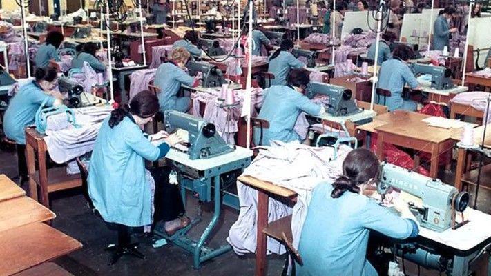 Workers seen at sewing machines 