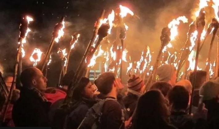 Bonfire visitors holding burning torches