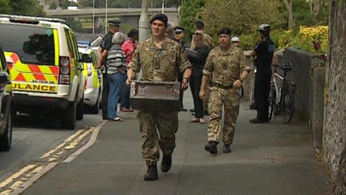 Royal Navy bomb disposal experts take WWII devices away