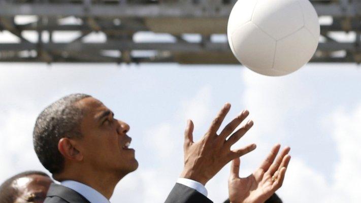 US President Barack Obama catches a "soccet ball" at Ubungo Power Plant in Dar es Salaam on 2 July 2013