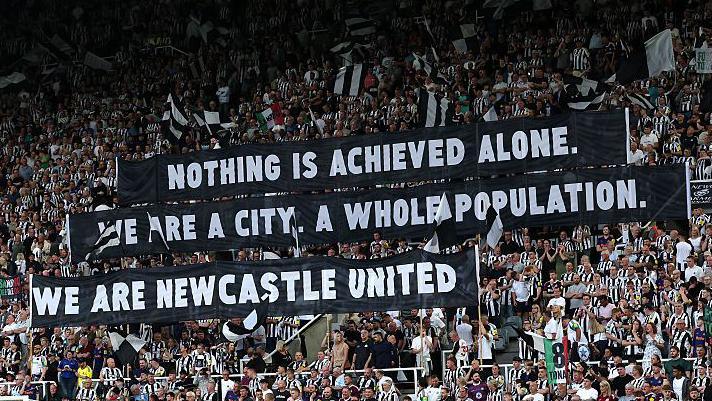 Newcastle fans hold up banners