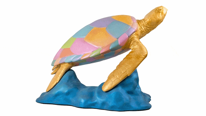 a multicoloured patchwork is painted on the shell of a turtle sculpture 