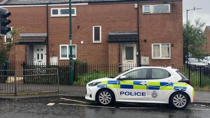 A police car outside a house in Hartley Road, Radford