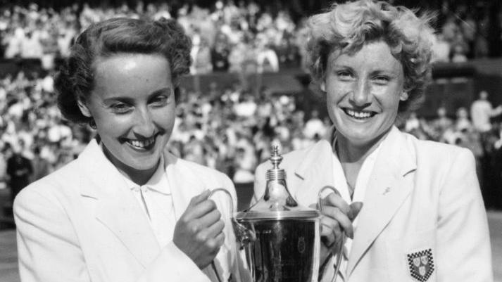 Angela Mortimer and Anne Shilcock hold the women's doubles trophy at Wimbledon in 1955