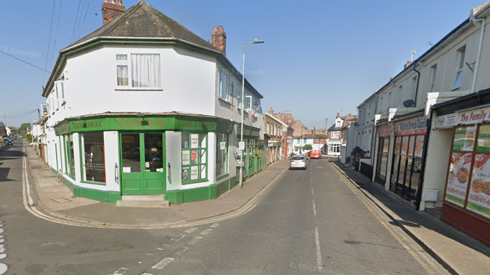 A view of Old Pier Street, Walton-on-the-Naze. The road is empty apart from a couple of vehicles in the distance