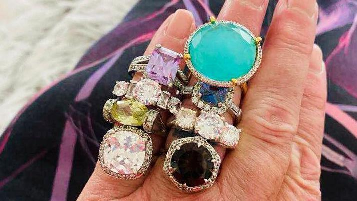 Eight bejewelled rings on a woman's fingers, after Susan Shepherd got stolen jewellery back.