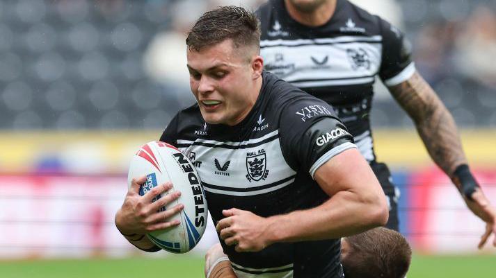 Hull FC's Cameron Scott is tackled by Leeds Rhinos' Ash Handley during the Betfred Super League match between Hull FC and Leeds Rhinos at MKM Stadium on June 15, 2024 in Hull, England.