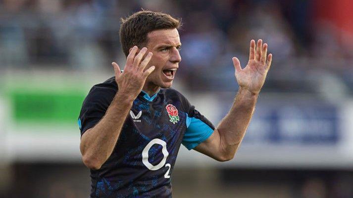 George Ford lifts his arms to rally his England team-mates