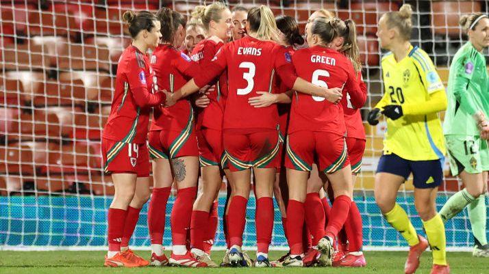 Wales players celebrate Kayleigh Barton's goal against Sweden