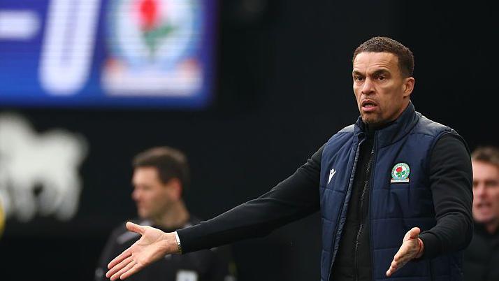 Blackburn manager Valerien Ismael spreads his arms out wide with his palms open in a sign of frustration