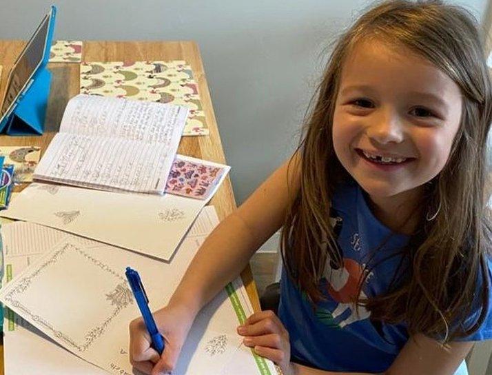 emilia-writing-a-letter-at-the-table