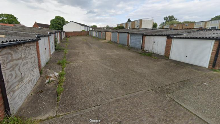 Garages on Merryhill Road in Bracknell -with blue and white doors others boarded up