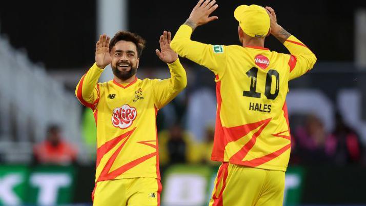 Rashid Khan and Alex Hales celebrate a wicket