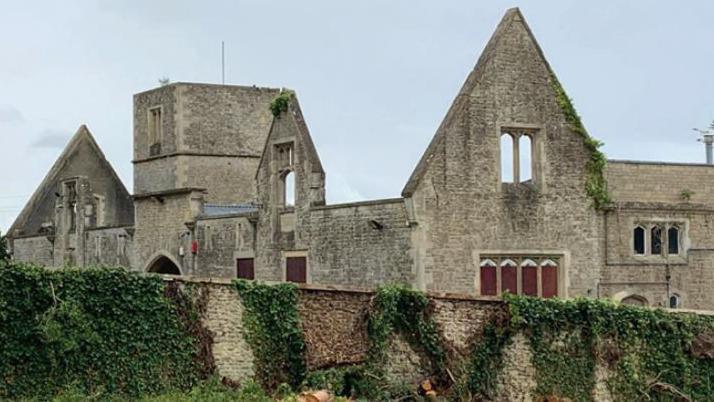 A former manor home with no roof and stone walls