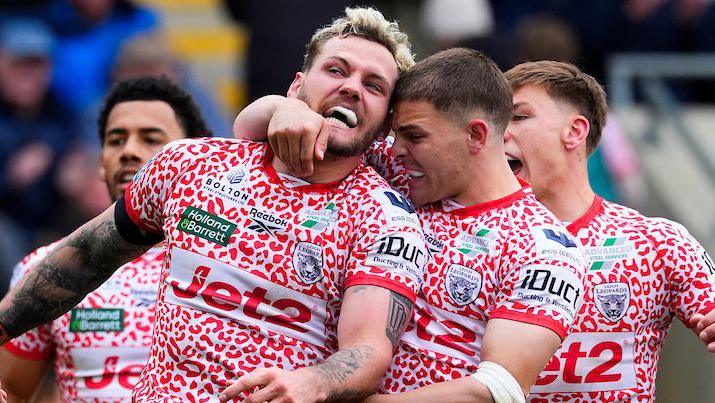 Leigh Leopards player Ethan O'Neill is congratulated by team-mates after scoring a try against Warrington Wolves