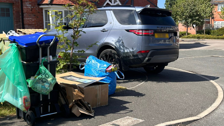 Uncollected recycling bins outside homes in Denbighshire