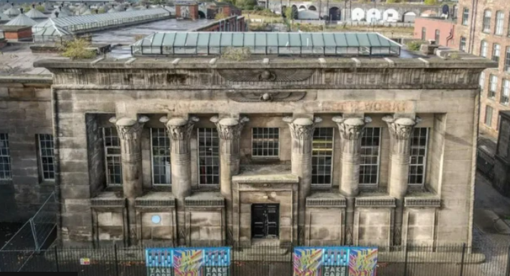 Temple Works mill in Leeds. A stone building with six pillars and glass roof.