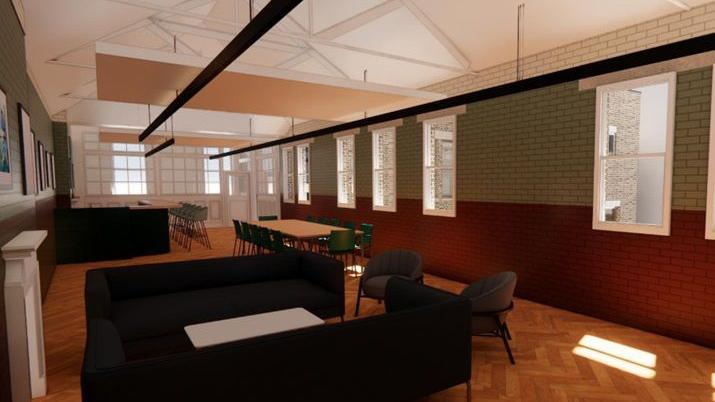 A CGI image of what the new venue's collaboration space will look like. The room is filled with sofas, chairs and tables. Large windows line one wall.