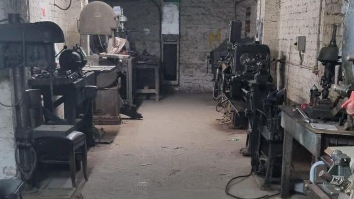 A present-day photograph of the tunnels where women had worked making munitions during the war. Some of the machinery remains in place.