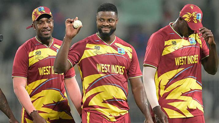 West Indies' Romario Shepherd shows the ball after taking five-wicket haul