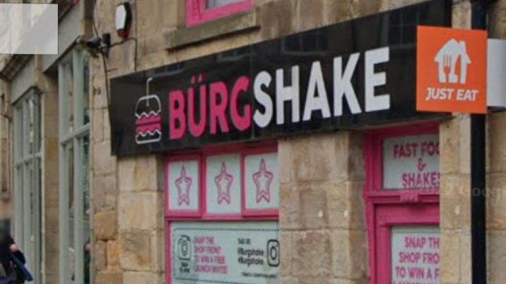 Bright pink signage on the front of Burgshake in Lancaster.