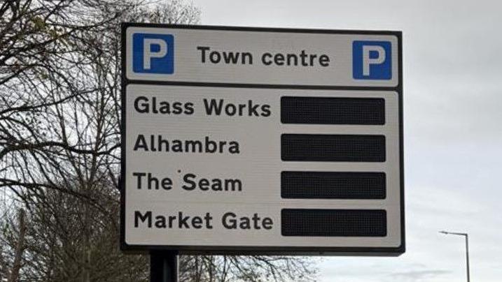 A road sign directing drivers to town centre car parks at Glass Works, Alhambra, The Seam and Market Gate.