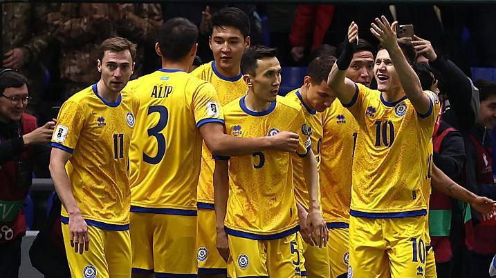 Kazakhstan players celebrate scoring against Belgium
