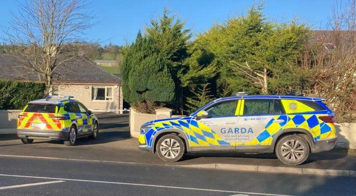 Two police vehicles pictured outside the house in Lifford, County Donegal. 