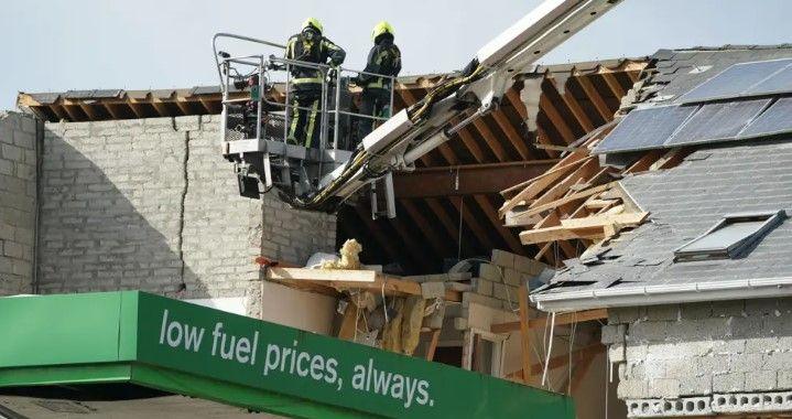 Two firefighters are seen near the blast site in October 2022