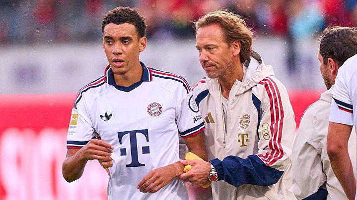 Jamal Musiala is helped off the pitch