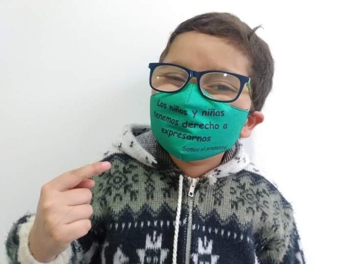 Francisco wears a mask reading "boys and girls have the right to free speech"