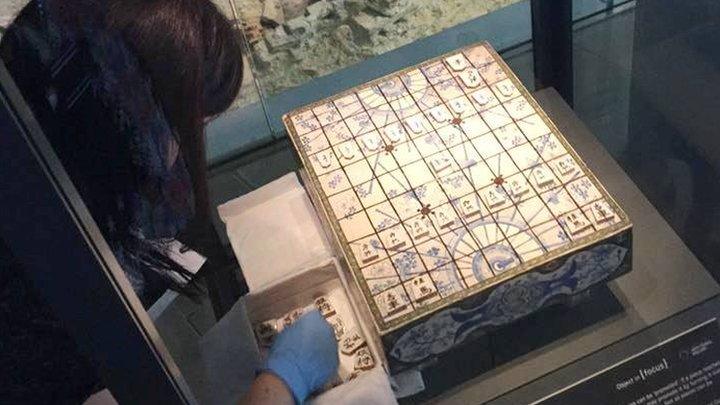 Curator installing the shogi set