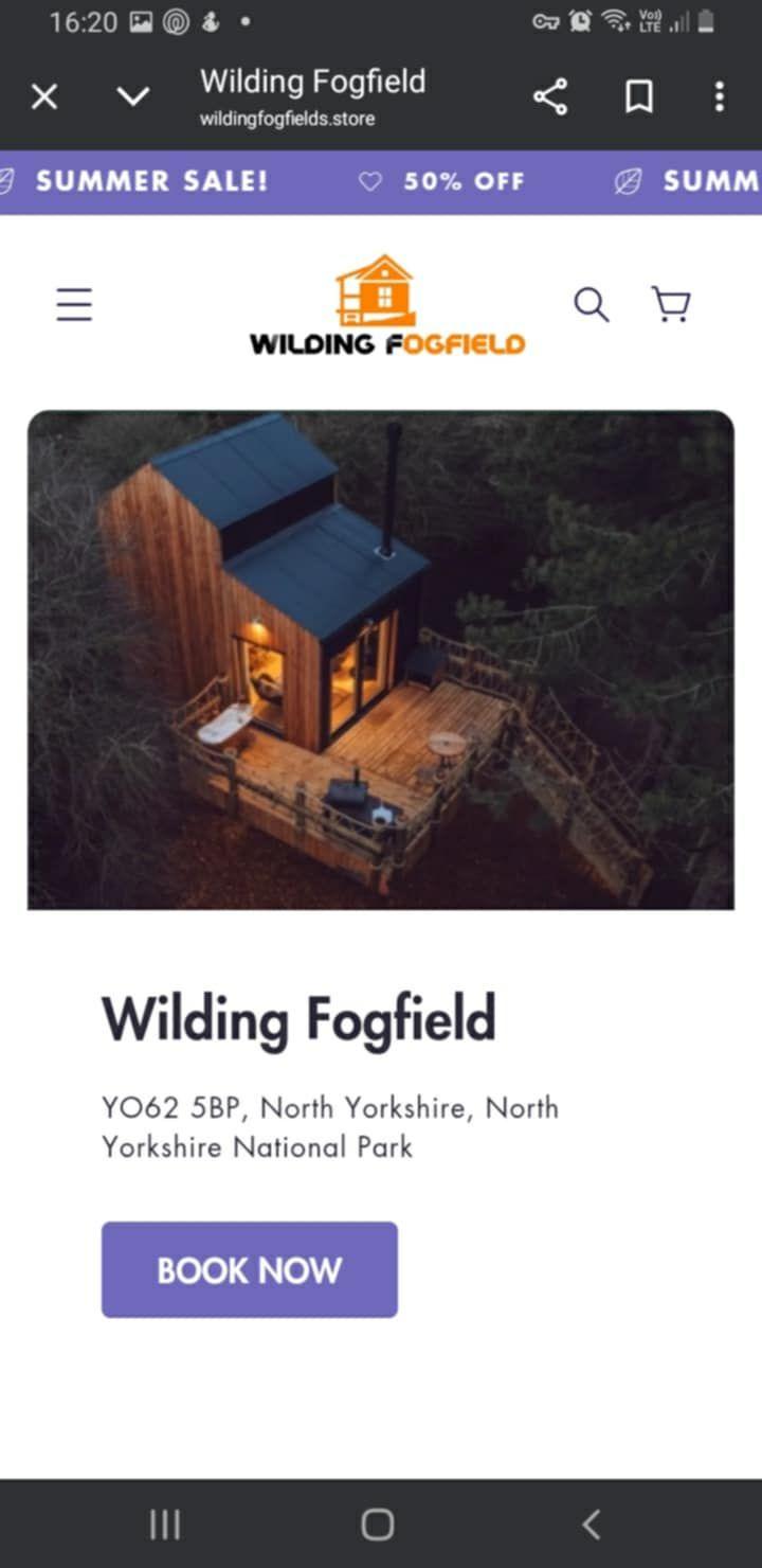 A screenshot showing a lowlit cabin in the forest from a birdseye view. Underneath it says 'Wildling Fogfield' with a big button saying 'book now'. 