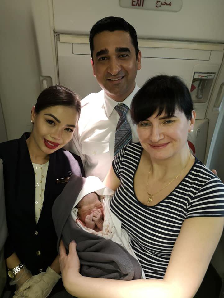 Alena Fedchenko with the baby boy and Qatar Airways crew