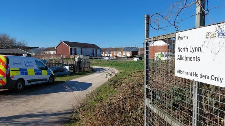 View of North Lynn Allotments, showing a sign saying 'Allotment holders only' and a police vehicle saying 'forensic services'.
