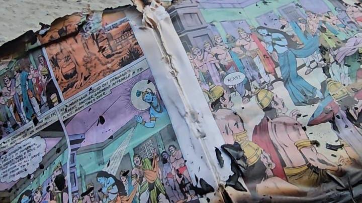 Damaged pages of an Amar Chitra Katha comic book with colourful illustrations depicting a scene from Indian epic Mahabharata.